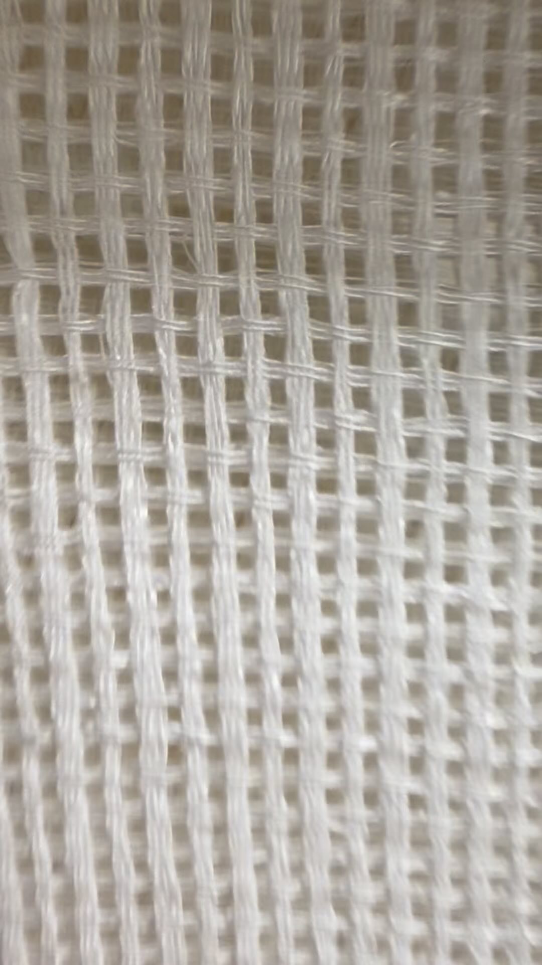 Close-up of a white net-like sheer fabric