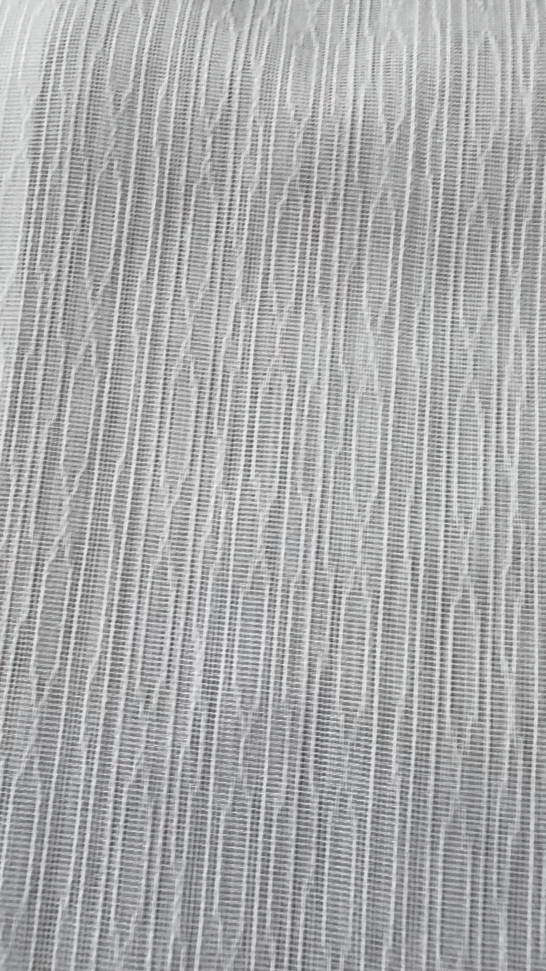 Close-up of a white sheer with an irregular vertical woven stripe